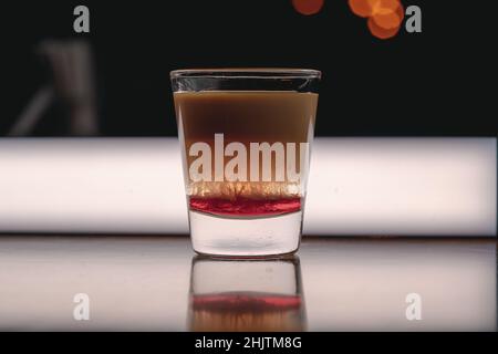 Brain Hemorrhage Tornado in shot alcohol drink based on cream, liqueur and grenadine with baileys Stock Photo