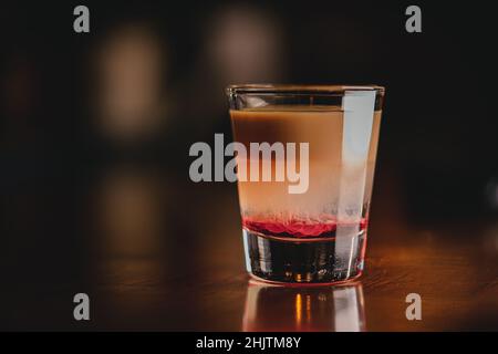 Brain Hemorrhage Tornado in shot alcohol drink based on cream, liqueur and grenadine with baileys Stock Photo