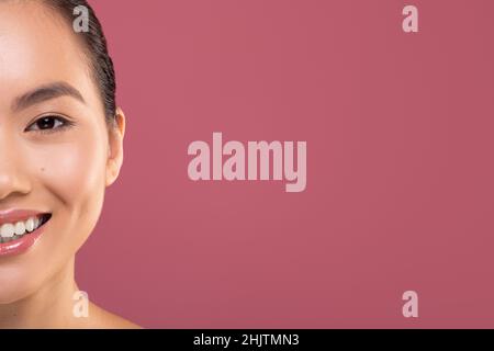 Half face of asian woman enjoying her beauty routine Stock Photo