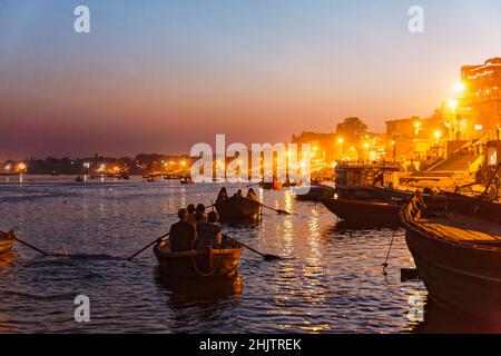 Rowing boats take tourists to the nightly aarti ceremony on the ghats on the River Ganges at Varanasi, a city in Uttar Pradesh, north India Stock Photo