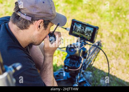 Shooting process on cinema stage - commercial production set, exterior location.Profeccional cameraman operates the camera Stock Photo