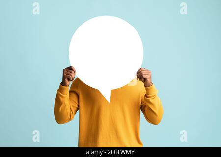 Black man hiding behind empty communication chart Stock Photo