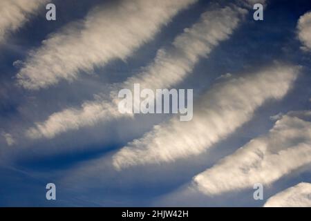 Cloud streets in blue sky, a type of cloud formation also known as horizontal convective rolls Stock Photo