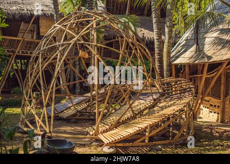 BALI, INDONESIA - MAY 2018: Green School Bamboo village, Traditional houses constructed by Bamboo with Thatch roof in the heart of Bali island. Very Stock Photo