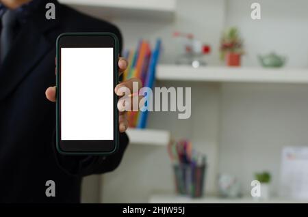 Mockup a mobile phone in the man hand. Blank screen with text or image for an advertisement. Stock Photo