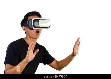 Virtual Experience. Excited Wearing VR Headset, Touching Air While Playing Video Game on white background. Stock Photo