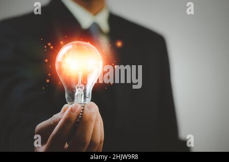 hand holding light bulb ideas Great inspiration and innovation Stock Photo