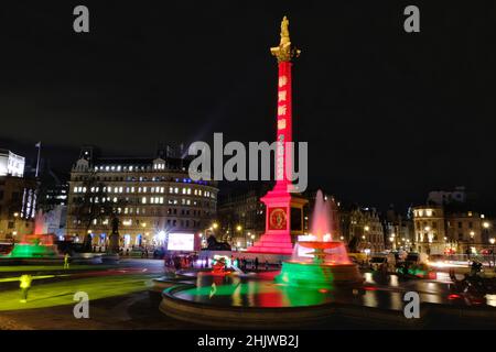 London, UK, 31st Jan, 2022.  Nelson's Column and Trafalgar Square is lit-up to celebrate Chinese New Year which falls on February 1st and ushers in the Year of the Tiger.  A lion and dragon dance was performed mainly for dignataries and officials as planned public celebrations were scaled back this year.  Credit: Eleventh Hour Photography/Alamy Live News