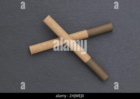 close up of cigarette on dark grey background Stock Photo