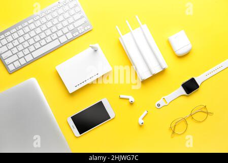 Different gadgets on color background Stock Photo