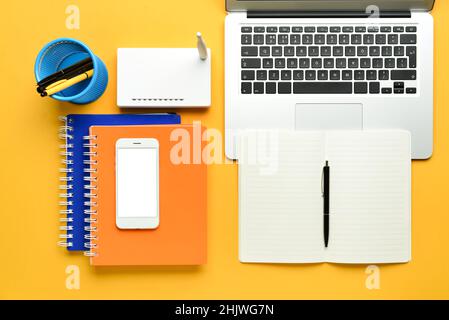 Different gadgets and stationery on color background Stock Photo
