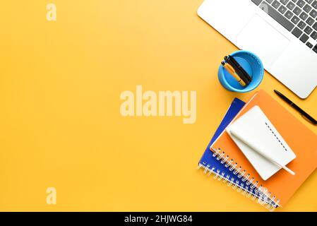 Different gadgets and stationery on color background Stock Photo
