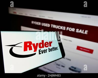 Smartphone with logo of American transportation company Ryder System Inc. on screen in front of business website. Focus on left of phone display. Stock Photo