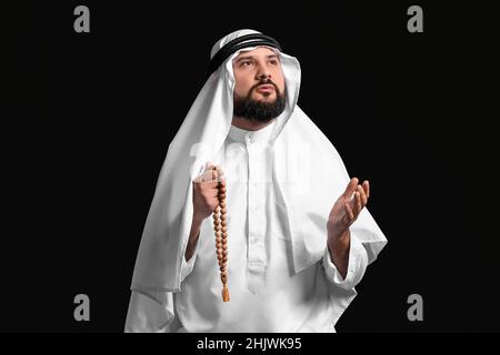 Muslim man praying on black background Stock Photo