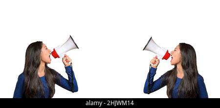 Two young women shouting at each other over megaphones from opposite ends of a panorama banner isolated on white with copyspace between in a conceptua Stock Photo