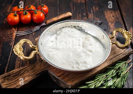 Straciatella fresh italian creamy cheese. Wooden background. Top view Stock Photo