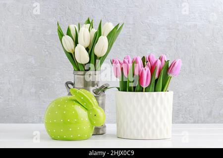 Easter decoration with green rabbit and tulips. Postcard motif, copy space. Stock Photo