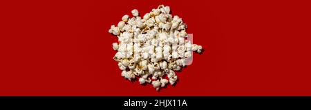 Popcorn heap on red background. Stock Photo