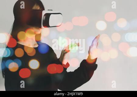 woman metaverse using virtual reality headset virtual reality device, simulation, 3D, AR, VR technology concept. Stock Photo