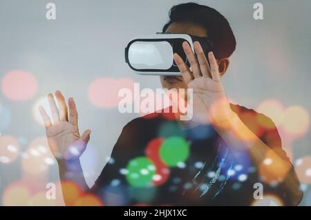 man metaverse using virtual reality headset virtual reality device, simulation, 3D, AR, VR technology concept. Stock Photo