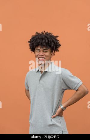 Portrait of smiling african american man  looking at camera, isolated on red background, Panama, Central America Stock Photo