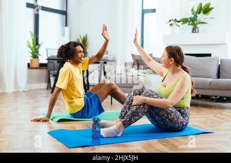 modern multiethnic unstereotyped couple doing meditation in the morning. Not stereotyped boyfriend and girlfriend together. Stock Photo