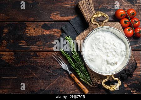Straciatella fresh italian creamy cheese. Wooden background. Top view. Copy space Stock Photo