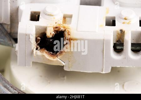 melted electrical outlet contacts close-up. High quality photo Stock Photo