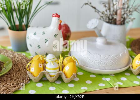 Easter table decoration in the kitchen with colored eggs. Stock Photo