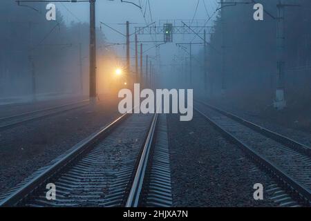 The train is traveling in bad cloudy foggy weather. Stock Photo