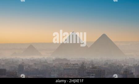 A view of the great pyramids of Egypt through the smog of Giza. Stock Photo