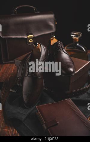 Pair of brown leather shoes with suitcase and diary Stock Photo