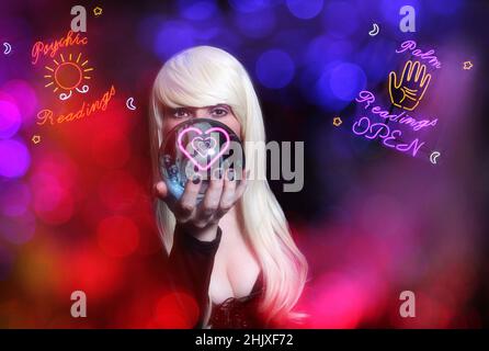 Psychic with Blond hair and Crystal Ball. Vintage Neon Lights in background Stock Photo