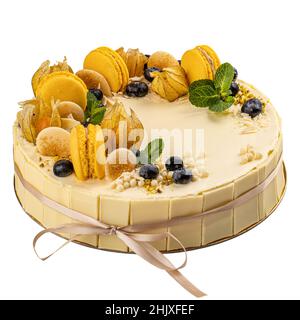 White chocolate cake decorated with blueberry and macarons isolated on white background Stock Photo