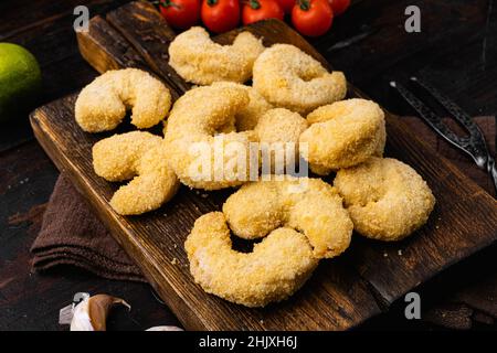 Raw breaded shrimp set, on black dark stone table background, top view ...