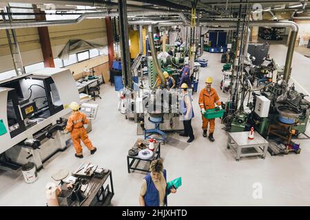 Female and male workers wearing uniform working in factory warehouse Stock Photo