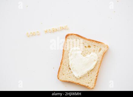 sandwich for breakfast in the form of heart with cheese - good morning inscription Stock Photo