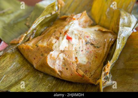 Top view of Steamed Fish in Red Curry Mousse in the banana leaf, focus selective Stock Photo