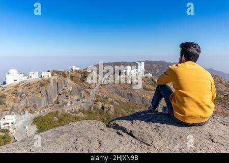 Hiker young boy over looking Aravalli Range with guru shikhar  Mount Abu, Rajasthan. Stock Photo