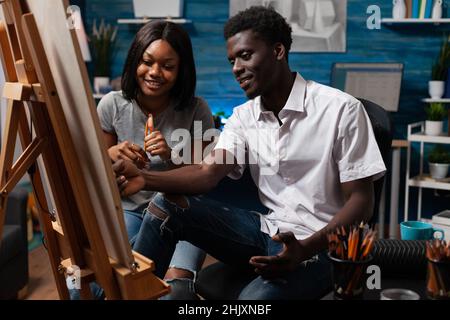Young designers looking at vase illustration drawing sketch on canvas using professional graphic pencil. Art students working at draw masterpiece in creative atelier Stock Photo