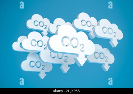 CO2 reduction concept. Cloud shaped objects with the word CO2 punched out and an arrow pointing down in front of a blue background. Stock Photo