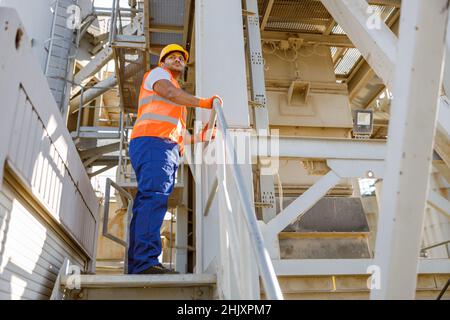 Serious African engineer standing at industrial site Stock Photo