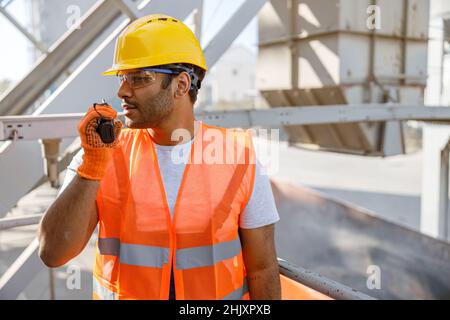 Young building industry worker working hard outdoors Stock Photo