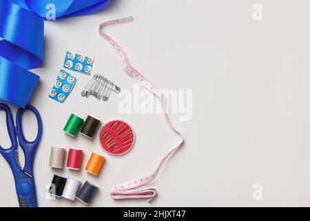 A set of sewing tools and accessories. Thread scissors needles. Top view flat lay copy space Stock Photo