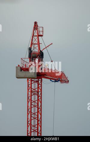 Professional crane operator inspecting the crane at high altitude,hazardous work concept Stock Photo