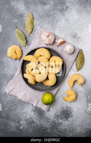 Raw breaded shrimp set, on black dark stone table background, top view ...