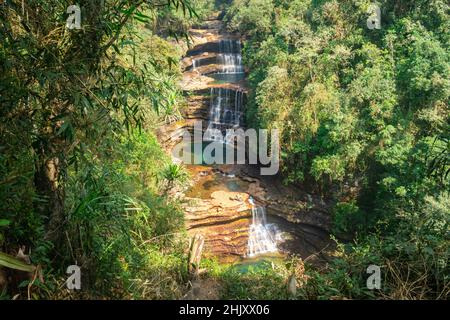 natural waterfall layered falling from mountain top in deep green forests at morning from top angle image is taken at wei sawdong falls cherrapunji so Stock Photo