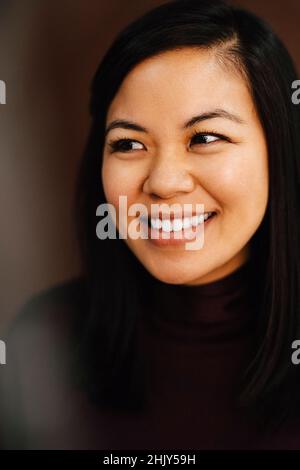 Smiling mid adult woman looking away in studio Stock Photo