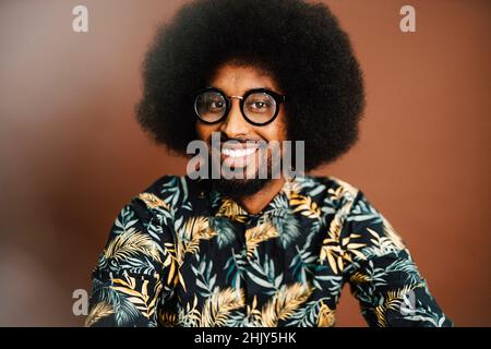 Portrait of smiling man with Afro hairstyle in studio Stock Photo