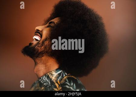 Cheerful young man laughing in studio Stock Photo